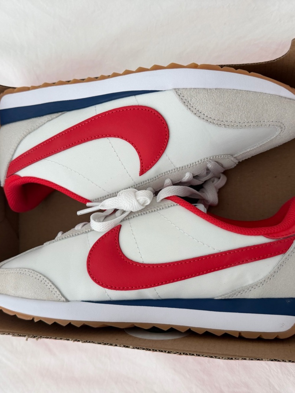 Nike White Sneakers with Red Swoosh and Blue Midsole Accent